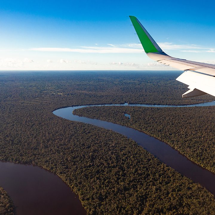 Airplane flying over the river